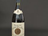 a bottle of red wine on a black background
