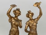 pair of antique bronze figurines of a woman and a bird