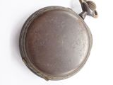 a pocket watch that is sitting on a white surface
