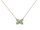 a gold necklace with a green butterfly pendant on a chain