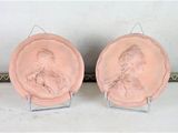 two pink plates with a picture of a man and a woman on them