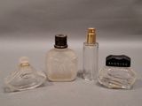 three perfume bottles sitting next to each other on a table