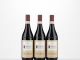 three bottles of wine sitting on top of a table next to each other