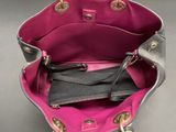 the inside of a pink and grey purse on a table