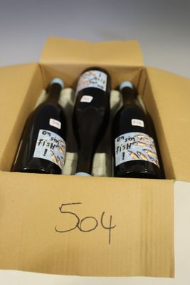 three bottles of wine in a cardboard box with a price tag