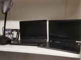 two laptops sitting on top of a shelf in a closet