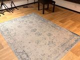 an image of a room with a chair and a rug