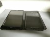 two cell phones sitting next to each other on a table