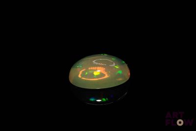 a light that is on in the dark with a black background