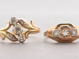 two gold rings with diamonds on them sitting on a table