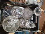 bottles and glasses in a basket on a table in a room