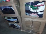 a stack of clothes on a pallet in a warehouse