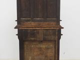 an old wooden piano sitting on top of a wooden stand