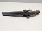 a close up of a gun on a table with a white background