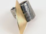 silver and gold plated ring on white background