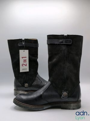 pair of black leather boots with a tag on the side of them