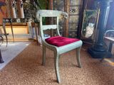 a chair with a red cushion on it in a room