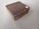 a small wooden box on a table with a tag on it