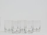 four glasses sitting next to each other on a table