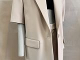 the mannequin is wearing a white suit and black top