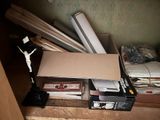 a cardboard box sitting on top of a desk next to a pile of papers
