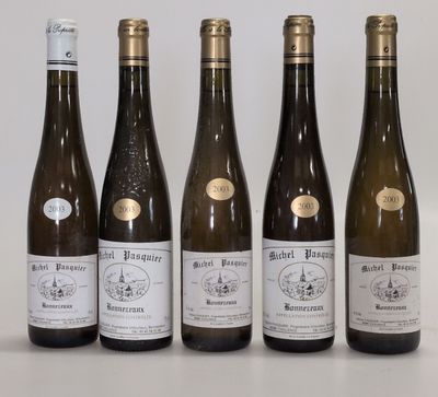 six bottles of wine are lined up on a table