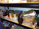 a shelf full of bottles and other items in a room