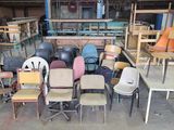 many chairs and tables in a room with a lot of them