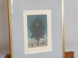 a picture of a tree in a picture frame on a easel