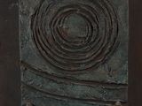 a close up of a piece of metal with a circular design on it