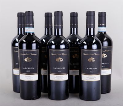six bottles of red wine are lined up in a row