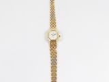 a close up of a watch on a white surface with a white background