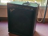 a guitar amp sitting on the floor in front of a window