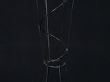a black and gold coat rack with five coats on it