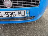 a blue car that has a license plate on it