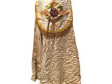 an image of a gold dress with a cross on it