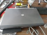a laptop computer sitting on top of a desk next to a keyboard
