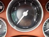 a close up of a car dashboard with various gauges