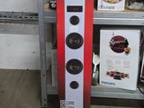a speaker that is sitting on a shelf in front of a shelf