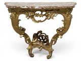 an antique console table with a marble top and gold leaf decoration