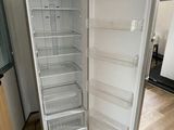 an empty refrigerator in the corner of a room
