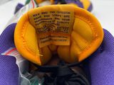 purple and yellow sneakers with a label on the inside of them
