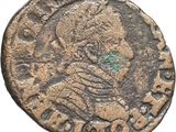 an old coin with a man ' s head on it