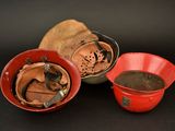 three red bowls and one red bowl with a hole in it