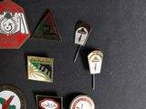 many different types of badges on a black surface