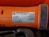 an orange and black electric drill sitting on top of a table