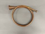an old brass hose with a brass handle on a gray surface