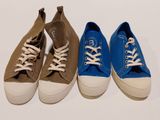 three pairs of blue, brown and white tennis shoes lined up on a white surface