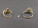 two gold rings with skulls on them sitting next to each other