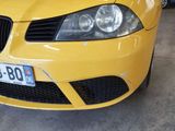 a yellow car that is parked in a garage